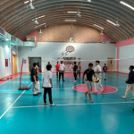 Organizing a break-time activity for students through the sports club activities at King Abdulaziz Schools, where students play volleyball and board games during the break to maximize engagement in physical activity Organizing a break-time activity for students through the sports club activities at King Abdulaziz Schools, where students play volleyball and board games during the break to maximize engagement in physical activity